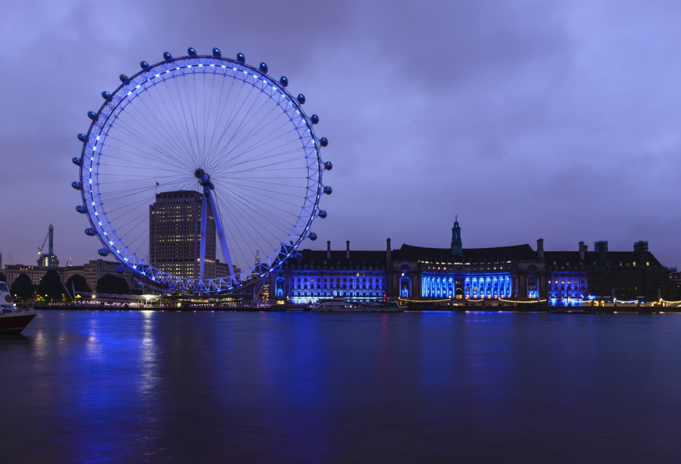 London Eye and waterfront lit up at night, London, United Kingdom