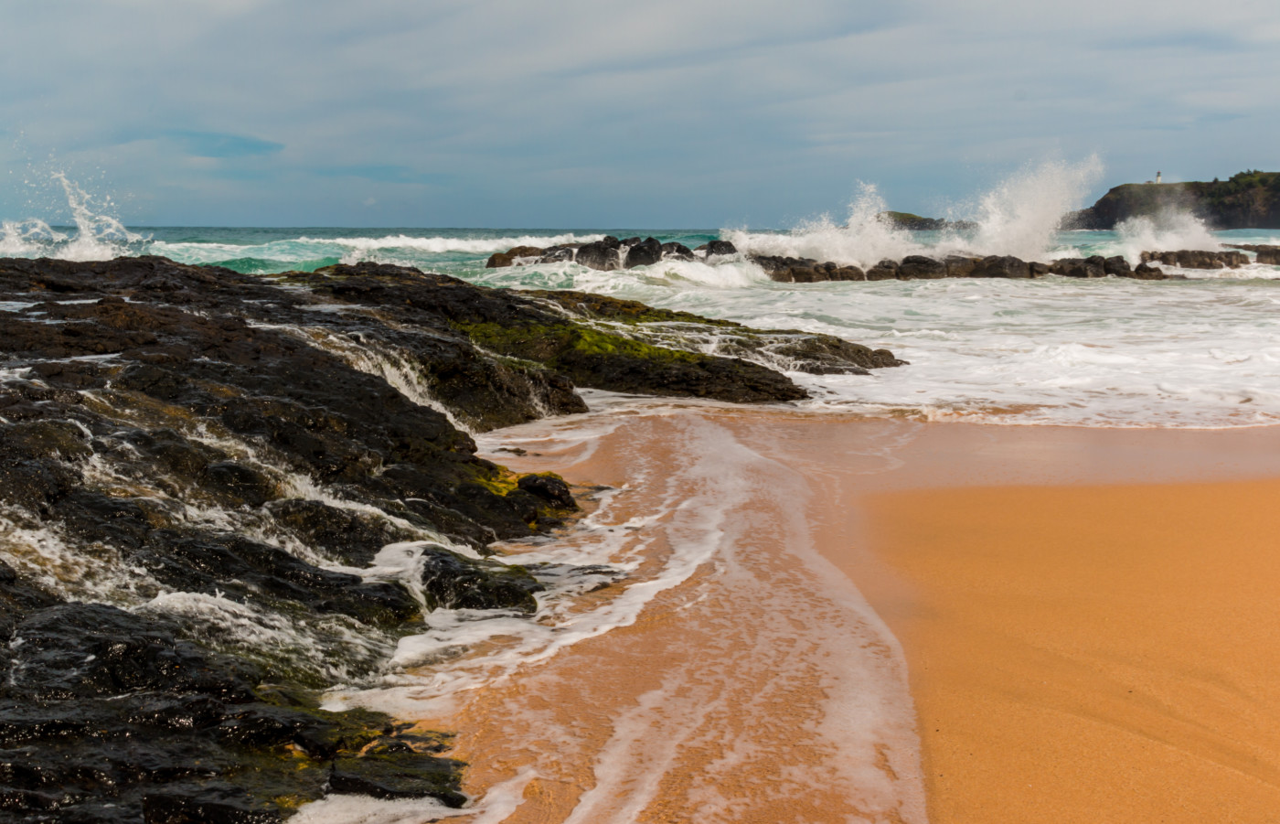 Waves Crash Over Exposed Coral Reef With Kilauea Lighthouse in The Distance, Kauapea Beach (Secret Beach), Kauai, Hawaii, USA