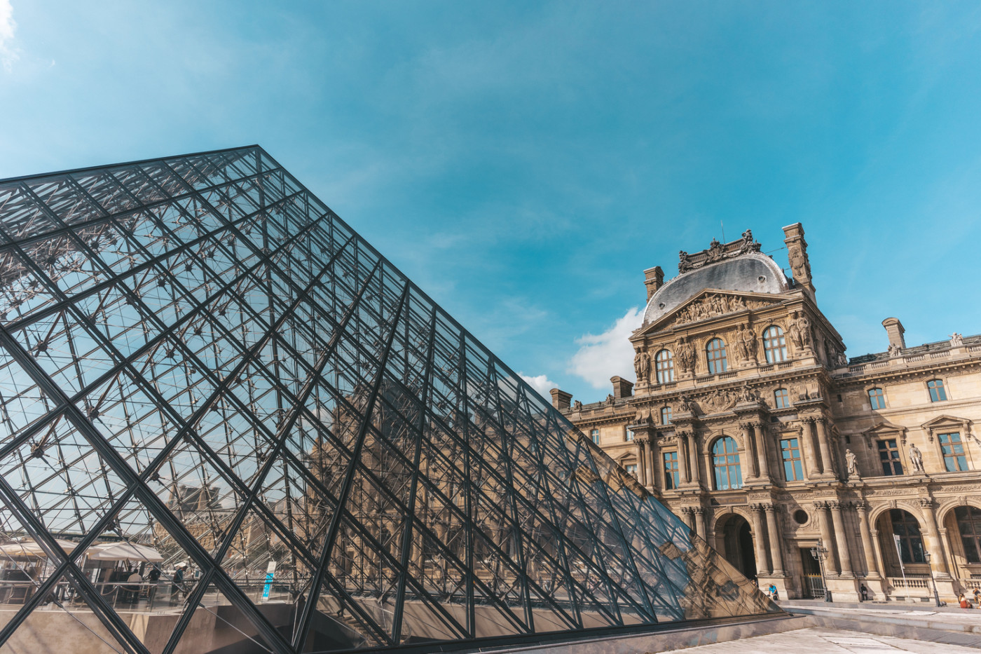 View of the Louvre Museum entrance with the baroque building on the background